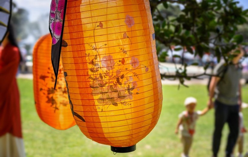 Orange lanterns hanging outdoors at a community event, symbolising Now NZ's secure and scalable telecommunications solutions for local government.