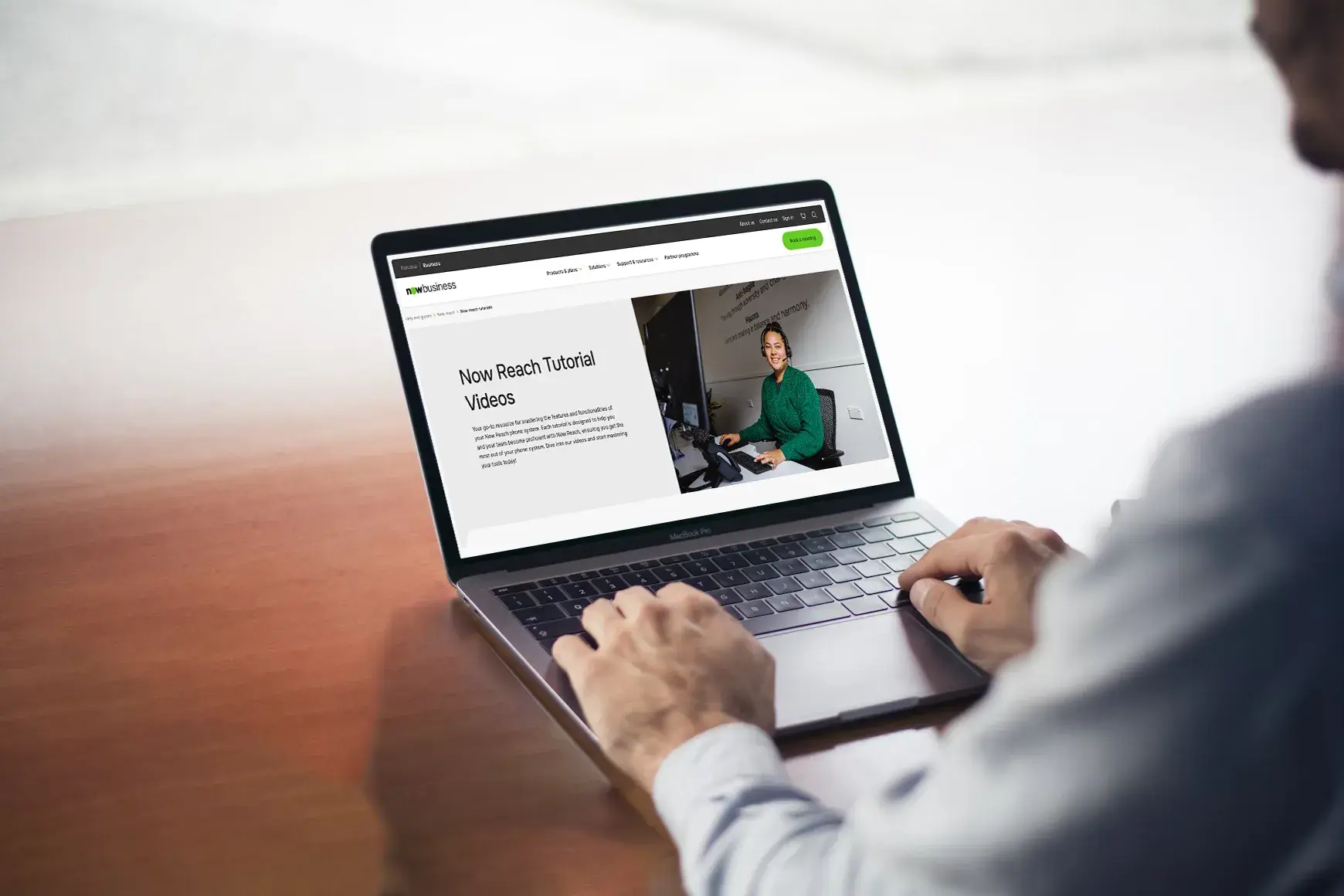 Person using a laptop to access the Now Reach Learning Centre tutorial videos, a resource hub for telecommunications support and device information.