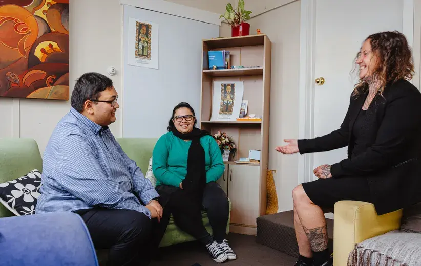 Charity workers in a warm conversation, representing Now NZ's partnerships with charities to foster compassion and create positive change in communities.