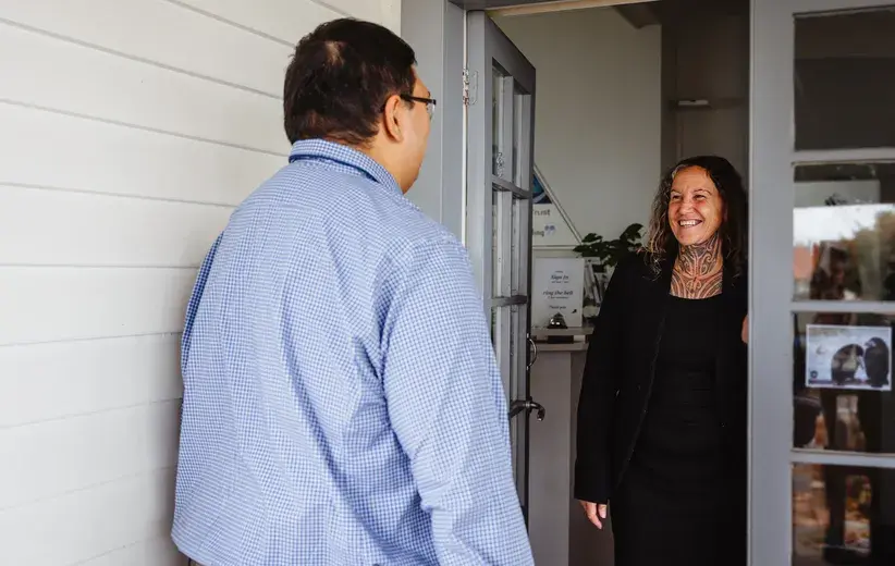 A representative from the Hawke's Bay Gambling Service warmly greets a visitor at the door, symbolising the strong partnership formed with Now. The organisation turned to Now for reliable telecommunications support to enhance their critical work in the community.