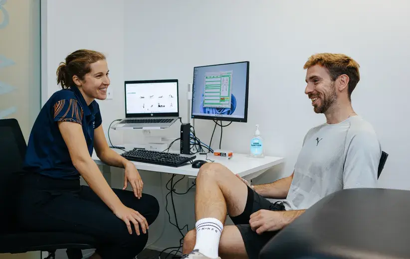 Physiotherapist consulting with a patient, showcasing Now NZ's smart, secure telecommunications solutions tailored for health and wellbeing practices.