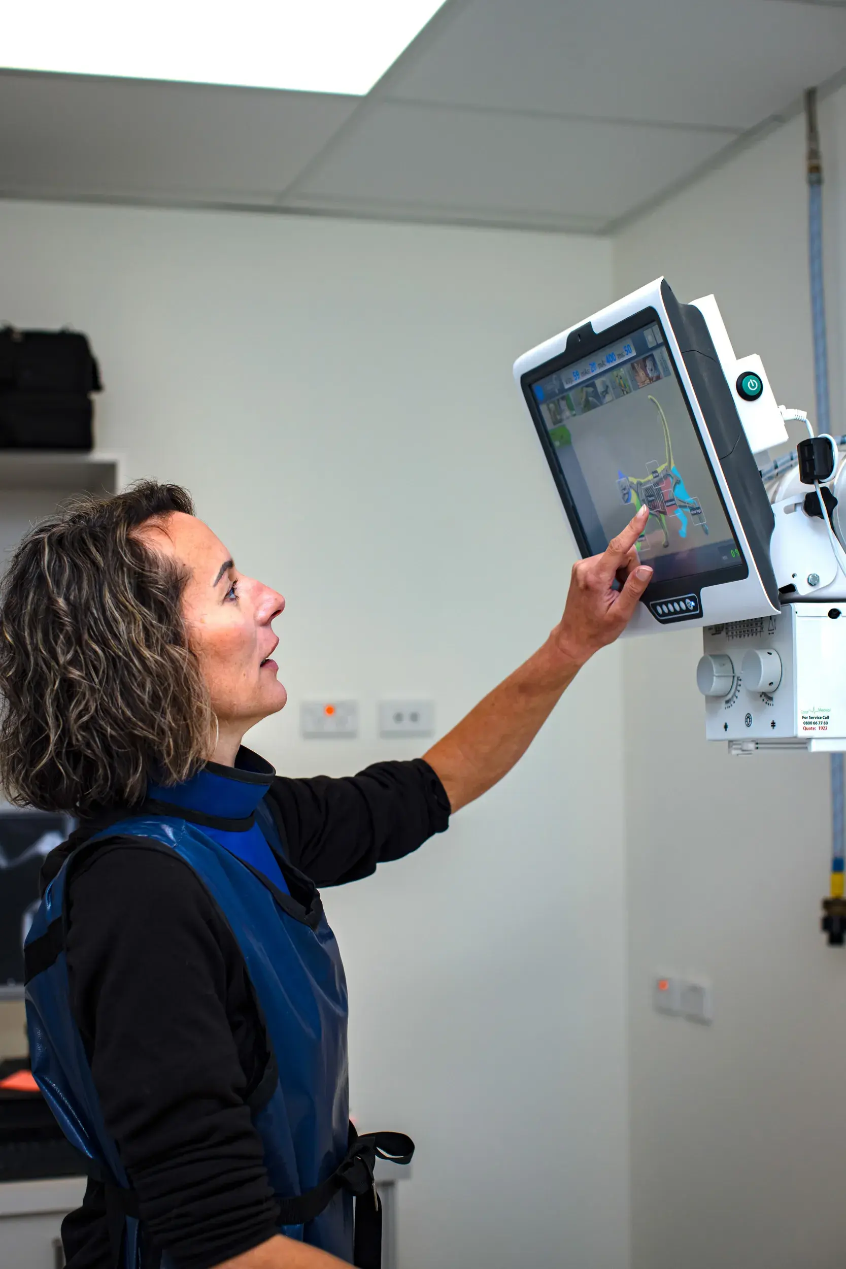 Healthcare professional operating an advanced X-ray machine, illustrating Now NZ's future-proofed telco technology solutions for improved care delivery in the health and wellness industry.