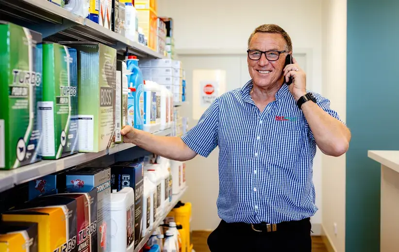 Male Now NZ customer smiling while talking on a phone in a store aisle, highlighting scalable telco solutions for medium-sized businesses.